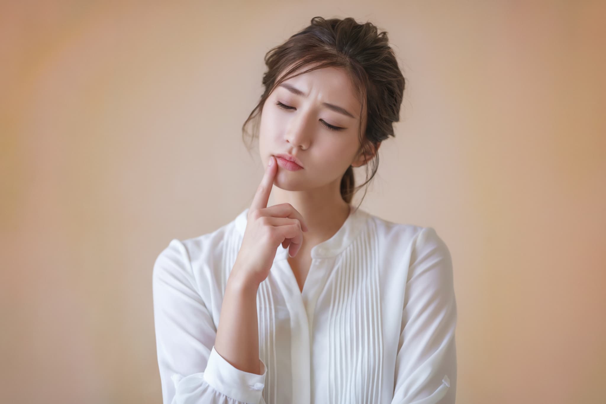 インビザラインで痛みを感じるのはどんなときか考える女性